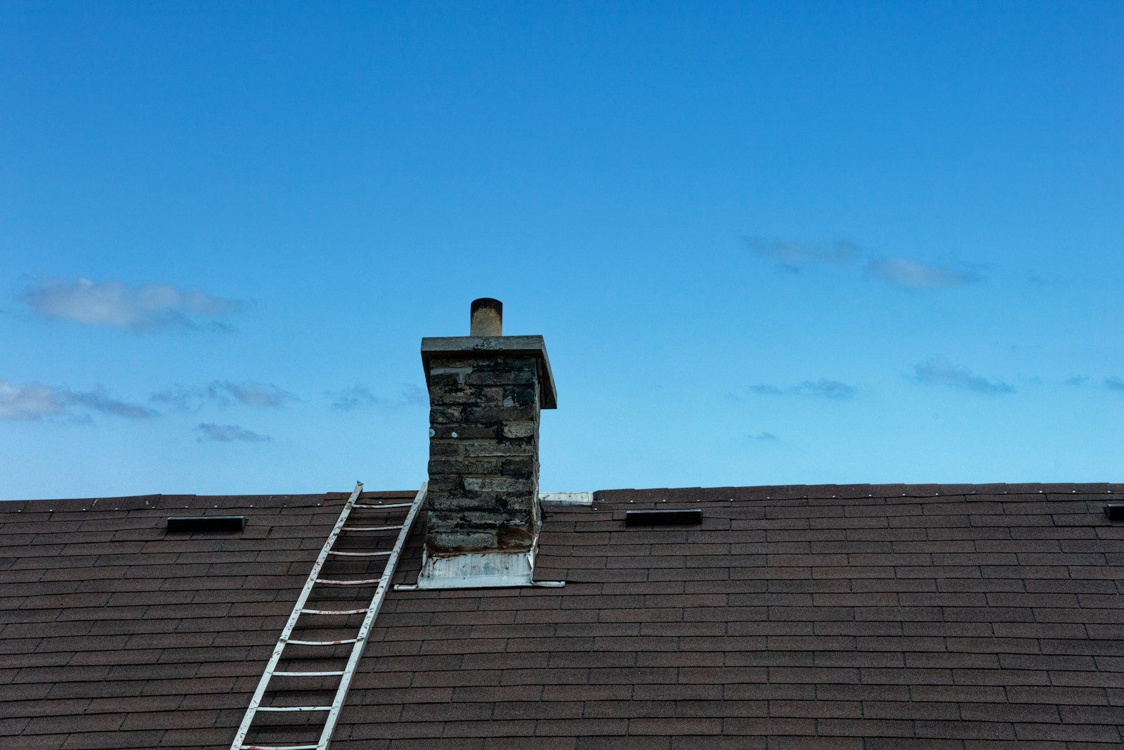 Ladder up to a capped chimney