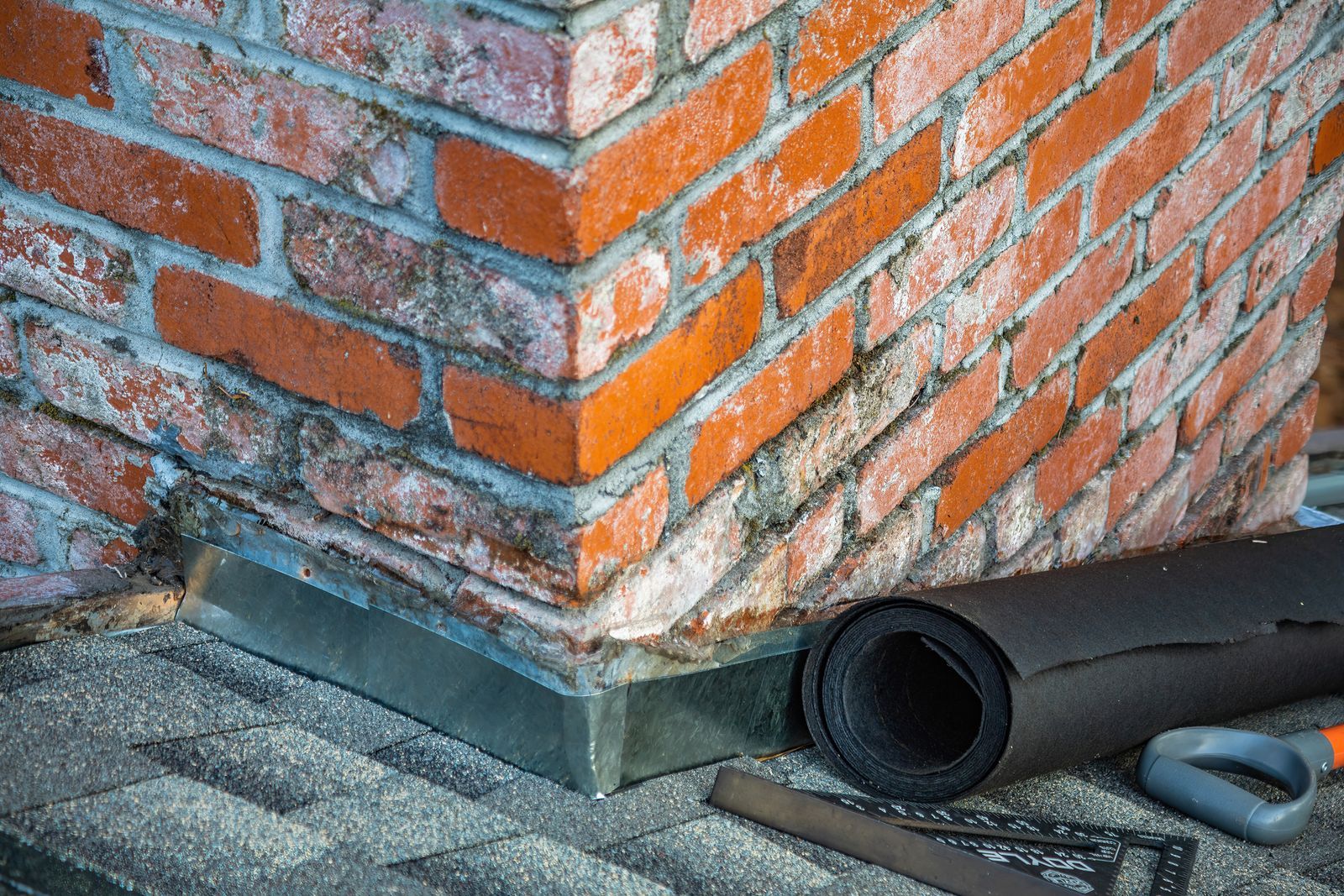 Step flashing at the chimney base