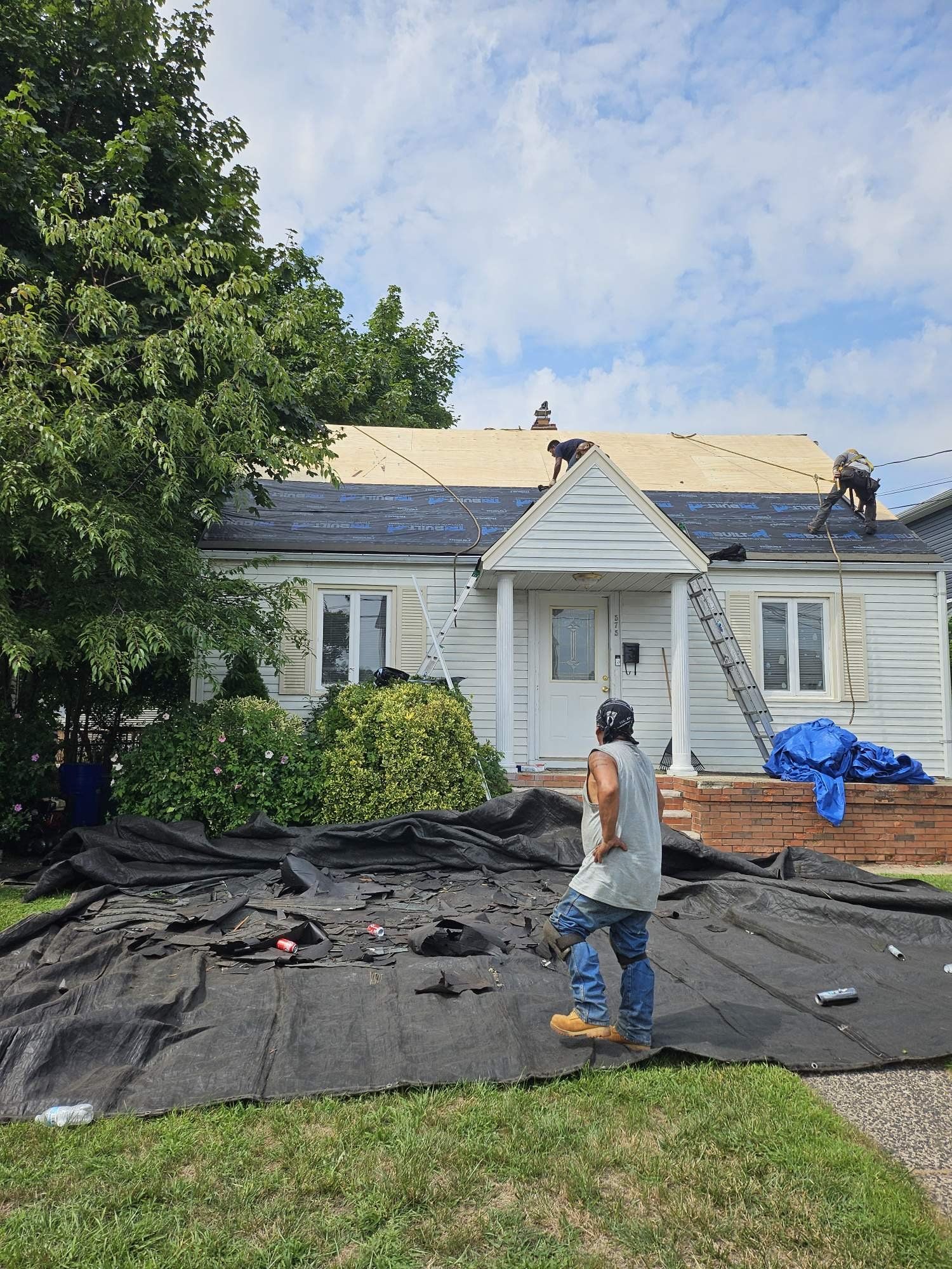 Cape Cod home during a roof tear-off, before the new roof