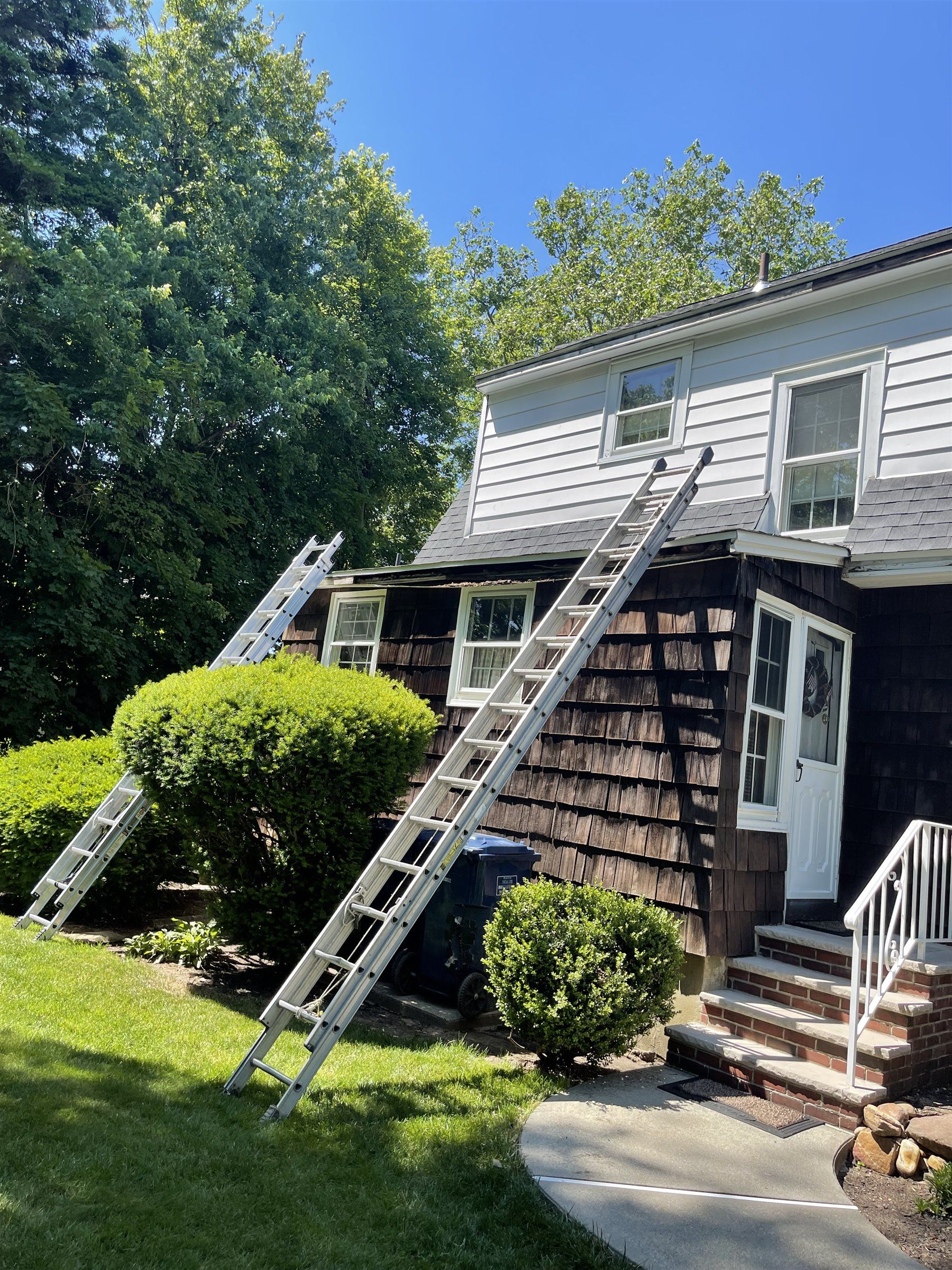 Two-storey home with cedar shake and white vinyl siding