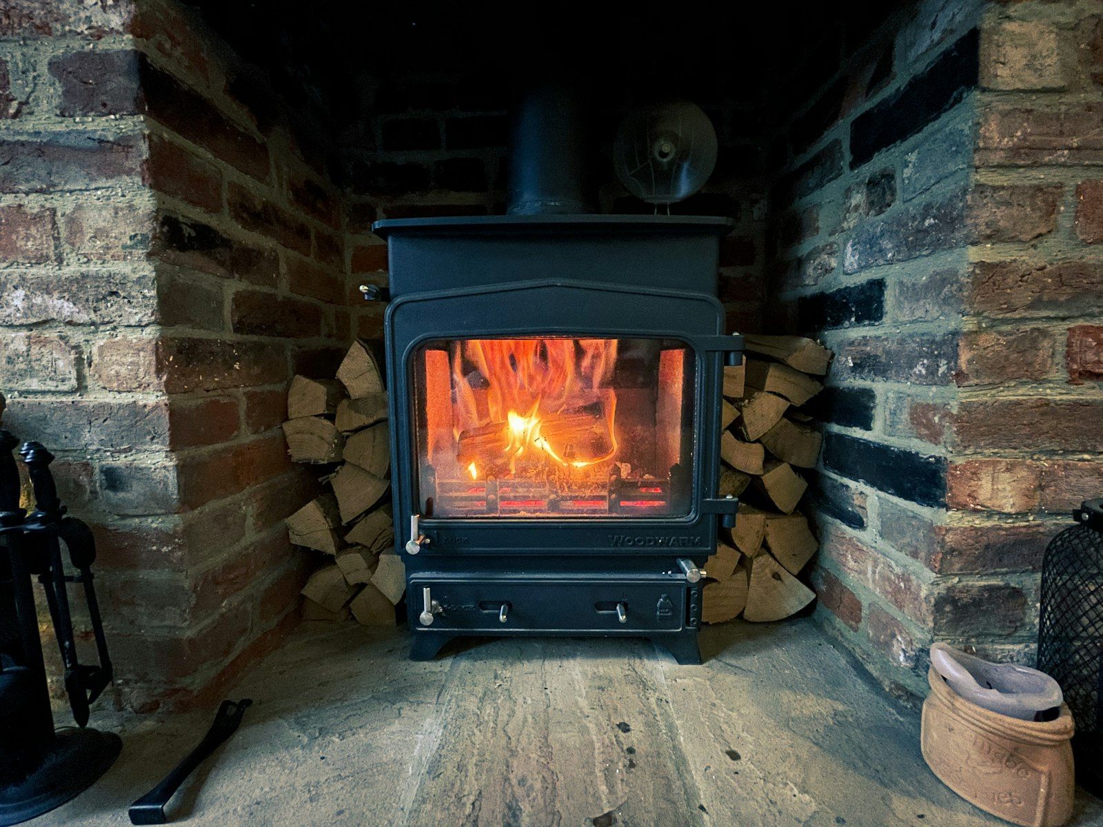 Wood stove in a brick hearth
