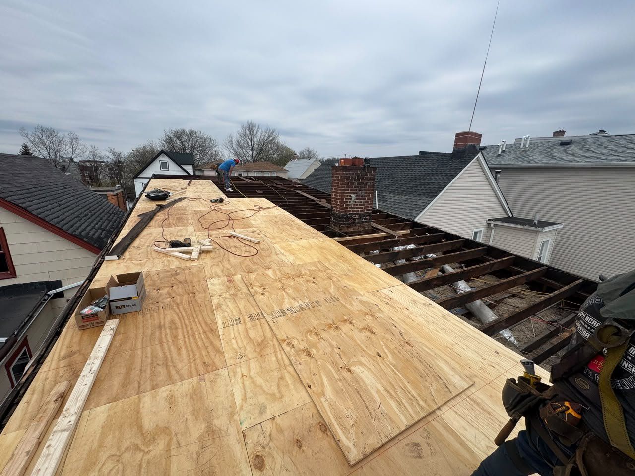 New plywood deck going down on a flat roof