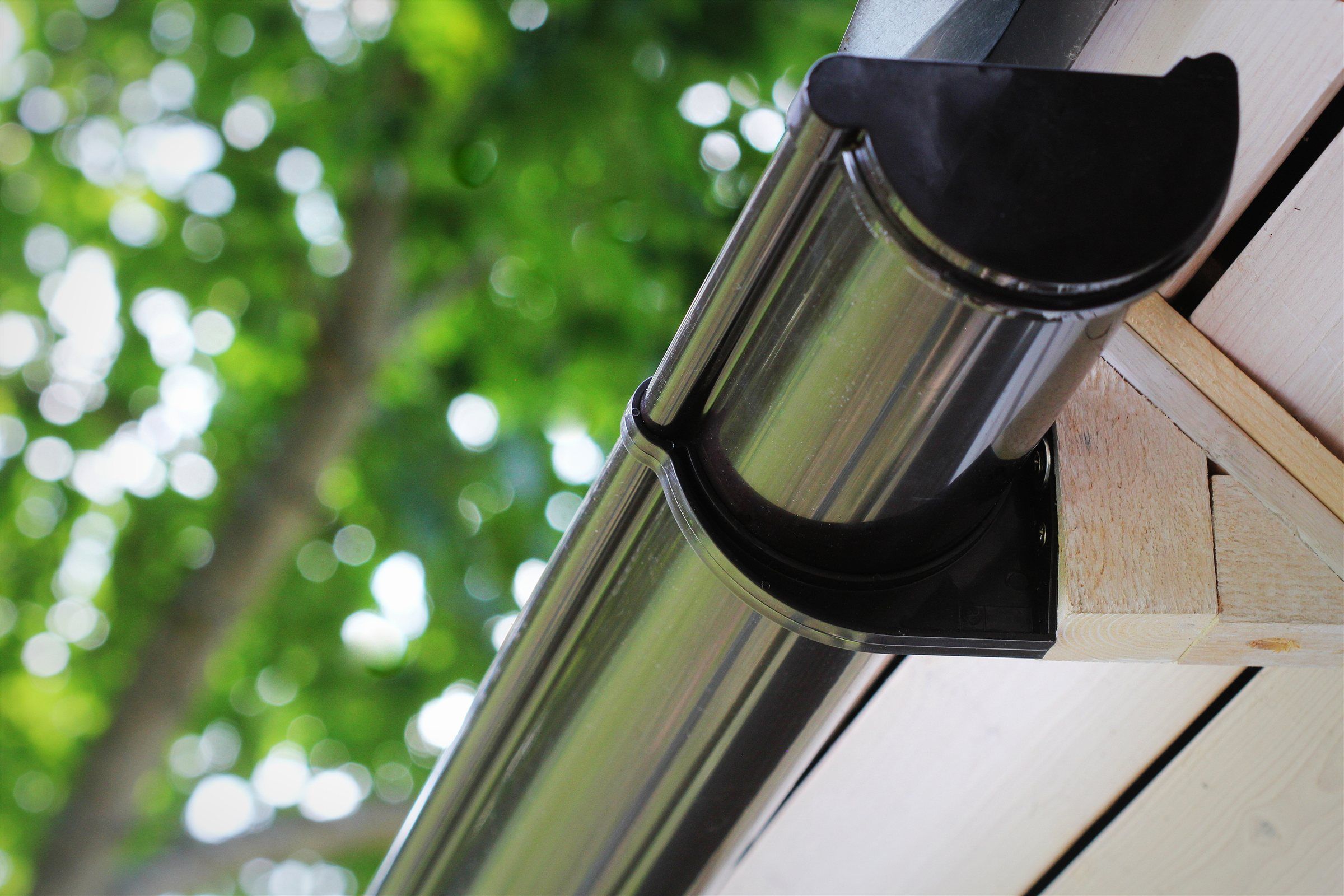 Close-up of a metal gutter and hanger along a roof edge