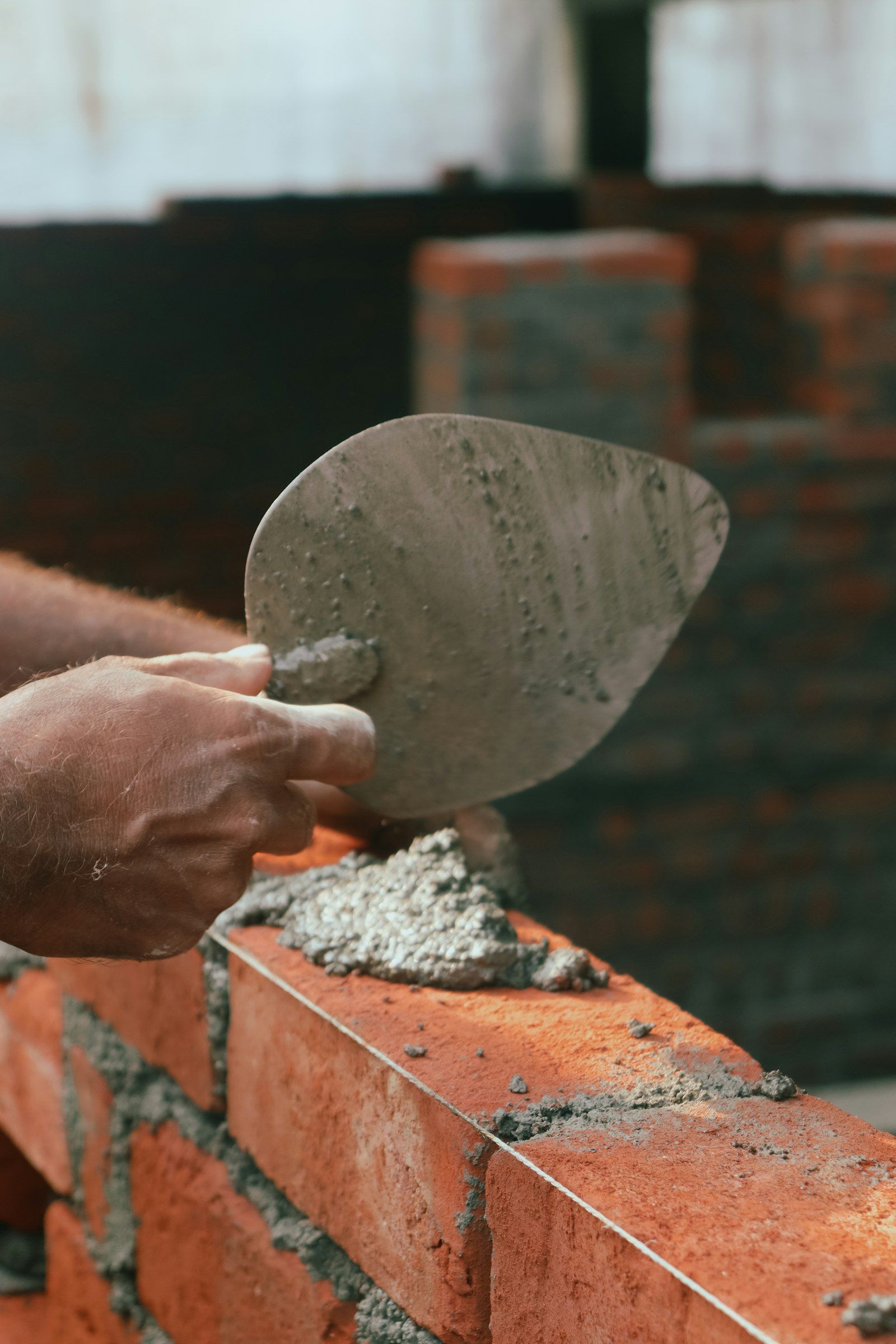 Trowel and mortar on brick
