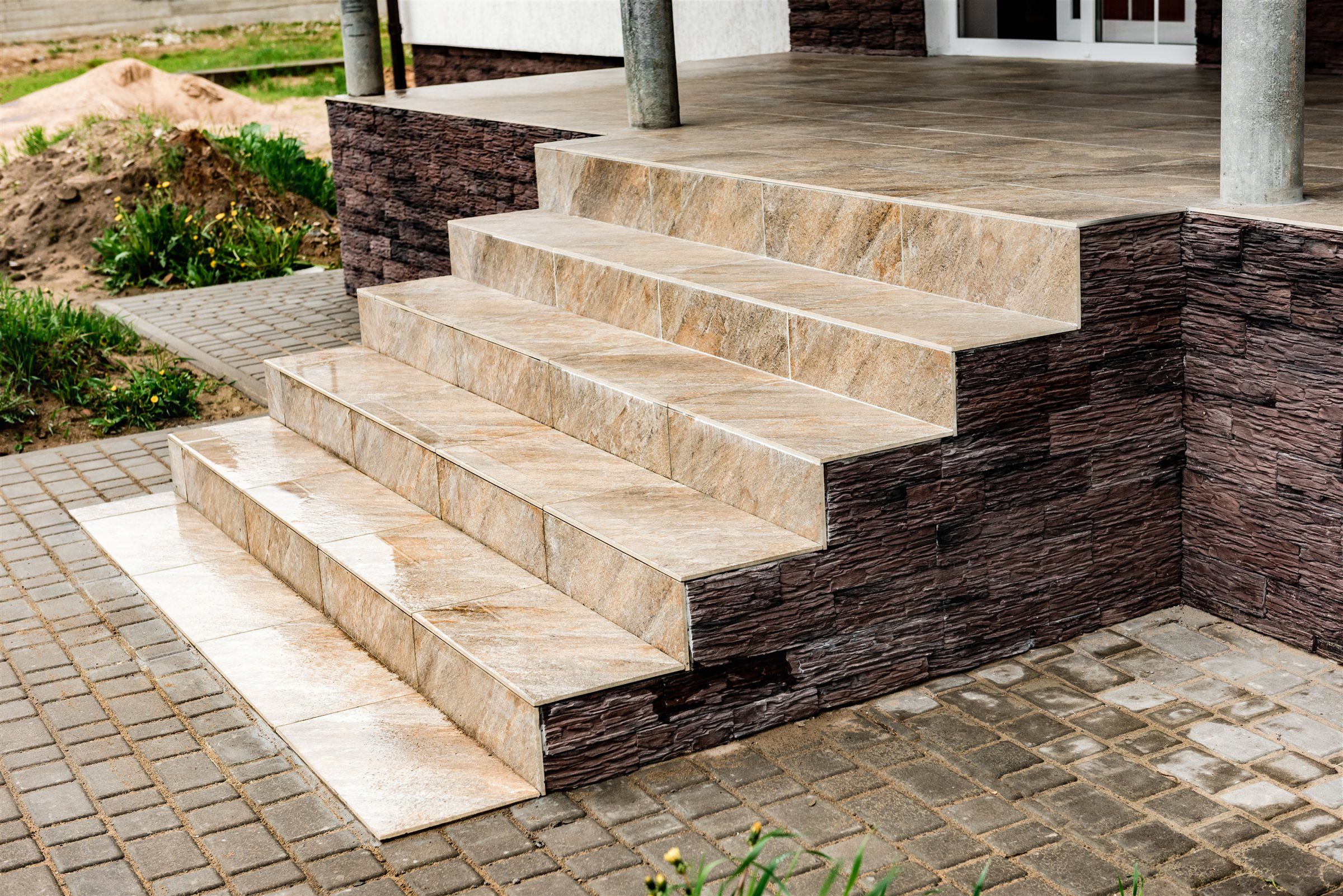 Stone front steps leading down to a paved walkway