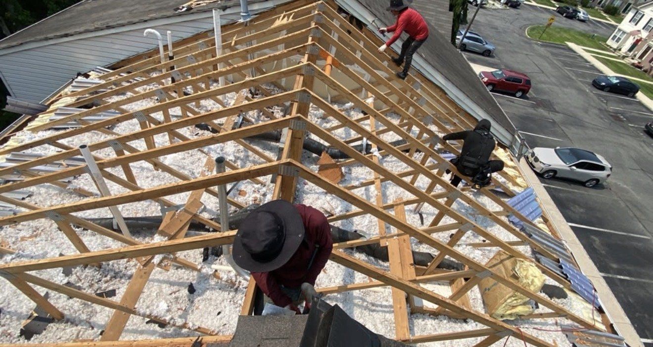ADZ Roofing crew installing new rafters on a roof