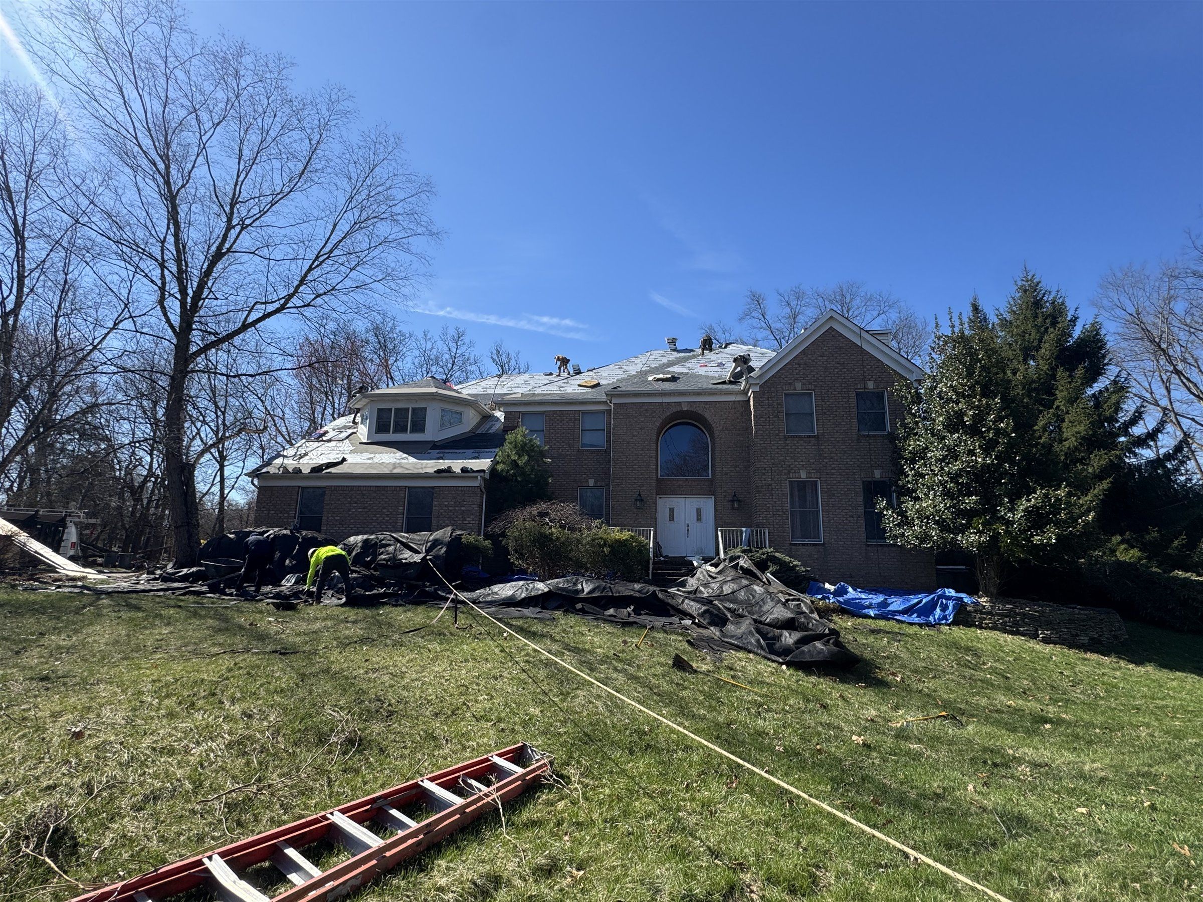 Roof tear-off debris cleared from the yard of a New Jersey home